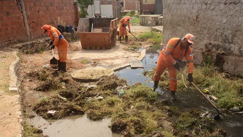 Imagem 1 -  O serviço de limpeza aconteceu no canal do doce no bairro Santo Antônio. Servidores da Semurb retiraram várias sacolas com lixo; metralhas; pedaços de madeira; restos de móveis e podas de árvores. O que dificulta a fluxo da água pluvial, ocasionando alagamentos. O trabalho estende-se pelas ruas Lira Tavares, Tavares de Lira e Francisco Pascoal. Além da limpeza do canal, também está sendo realizado serviço de capinação, limpeza de calhas e varrição. Outro canal que recebeu o mutirão de limpeza foi o do Redenção, na Rua do Eletricista.
