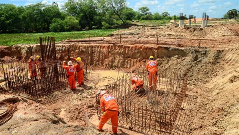 Imagem 1 -  A Construtora CLC e as equipes da Secretaria Municipal de Infraestrutura estão com trabalho concentrado, nesta etapa, na construção da ponte sob o Rio Mossoró, que terá uma extensão de 140 metros de vão.  Engenheiro da Secretaria de Infraestrutura, Felipe Augusto fala do empenho da Prefeitura e das equipes da Secretaria para a entrega da obra. " Esta é uma obra gigantesca, e todas as equipes têm se esforçado para que esse sonho seja concretizado".  O canteiro da obra é outra importante frente de trabalho, estão sendo construídos as vigas e estruturas que serão montadas nas colunas da ponte. 